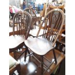 Three elm and ash seated spindle back chairs, and a ladder back chair.