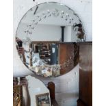 A round bevelled mirror and another vintage mirror with painted decoration.