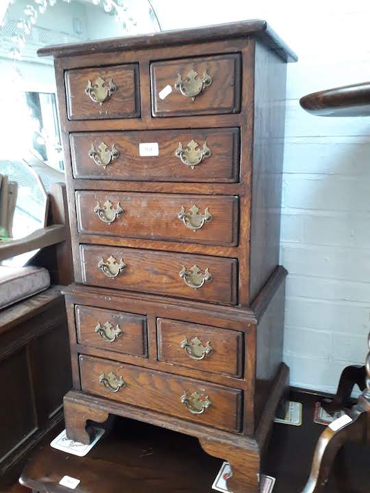 An aged oak reproduction Georgian style small chest on chest.