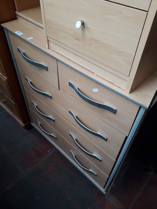 A light wood effect chest of drawers