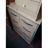 A light wood effect chest of drawers