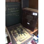 A collection of books and a portfolio of photographs including Don Quixote, etc