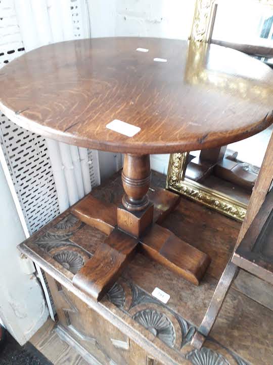 An aged oak round occasional table
