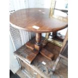 An aged oak round occasional table