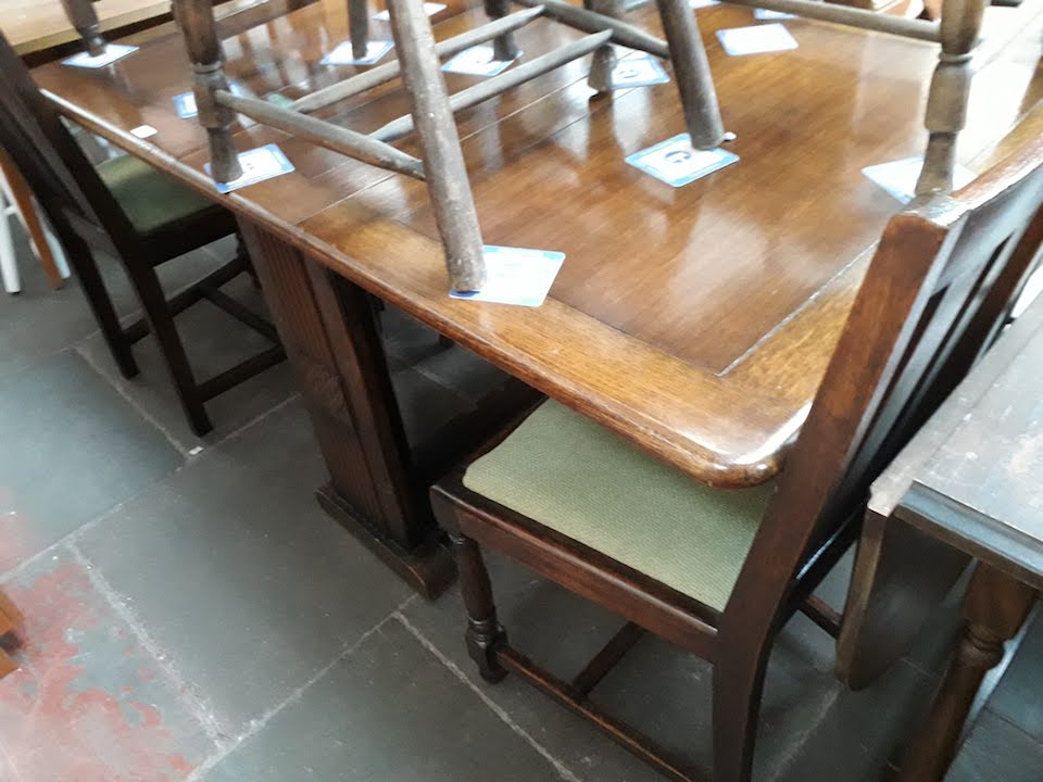 A 1930s oak drop leaf dining table with 2 pairs of oak chairs