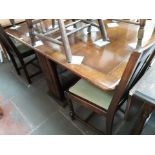 A 1930s oak drop leaf dining table with 2 pairs of oak chairs