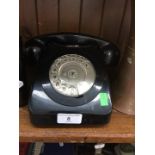 A vintage black telephone.