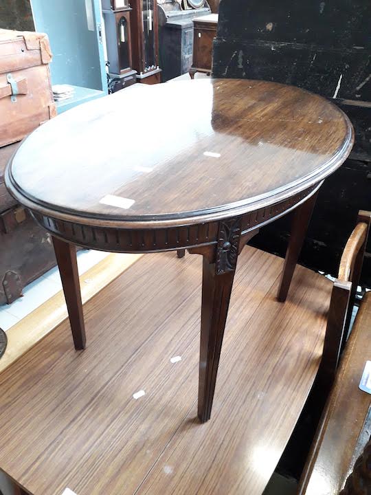 An oval mahogany coffee table