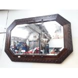 An oak framed bevel edged mirror