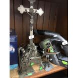 A white metal crucifix with triple layer base and 3 metal models.