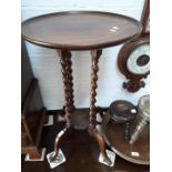 A round top side table with four twist pillars