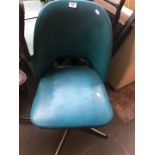 A retro blue office swivel chair.