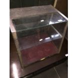 A chrome and glass table top cabinet.