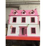 A large pink dolls house