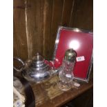 A mixed lot of silver plate comprising a teapot, a sugar castor, a photograph frame and a