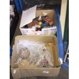 A box of glass and a box of toys to include dolls, etc.