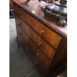 A figured walnut chest of drawers.