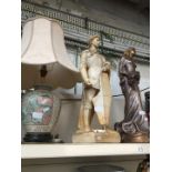 Two large figures and a table lamp