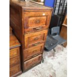 A 1920s four drawer oak filing cabinet.