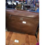 A Hidedesign suitcase, grab / messenger bag in brown leather.
