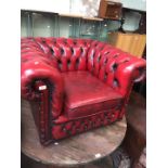 A oxblood leather tub chairs.