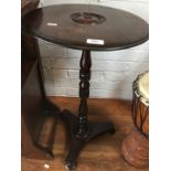 A rosewood wine table with bull's eye top, turned pedestal, triform base and bun feet, second