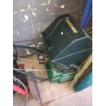 A Qualcast petrol Suffolk punch lawnmower (Handle broken)