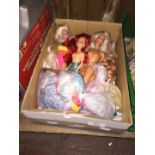 A box of various Barbie dolls