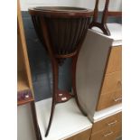 An Edwardian mahogany plant stand.