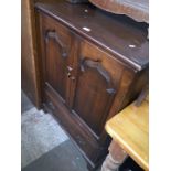 An aged oak TV cabinet.