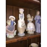 Small lladro figure of a girl with basket and three Nao figures