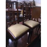 A pair of Edwardian high back chairs.