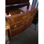 A figured walnut chest of drawers.