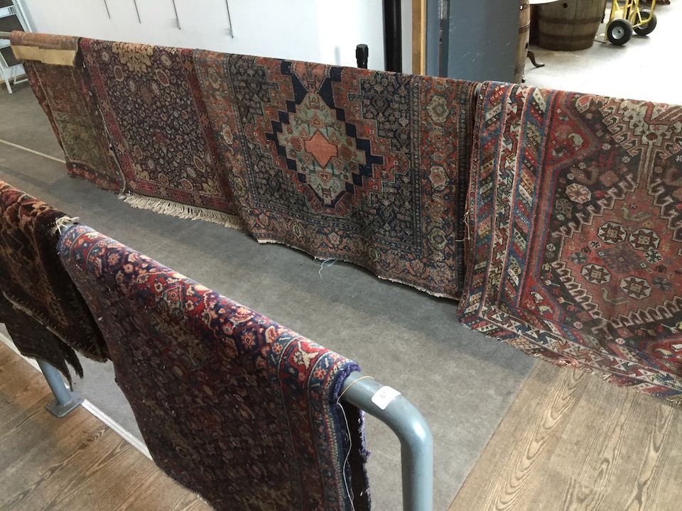 A group of eight eastern carpets and runners, various colours and patterns, as found.