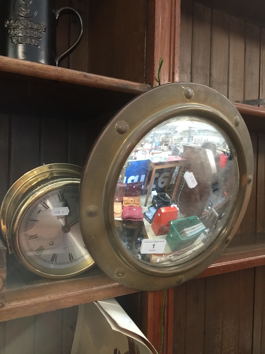 A circular brass mirror and a Vetus ship's bell - Made in Holland.