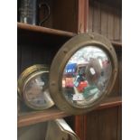 A circular brass mirror and a Vetus ship's bell - Made in Holland.
