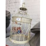 An ornamental metal birdcage