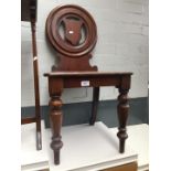 A Victorian mahogany hall chair.