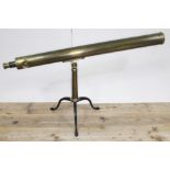A late 19th century 3" astronomical brass telescope on tripod base.
