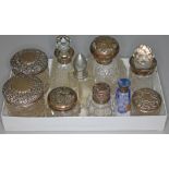 A group of nine hallmarked silver topped or mounted glass bottles and jars and another.