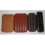 A group of four leather cigar cases.