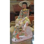A vintage Italian pottery figure depicting a girl holding a basket of fish by Tiziano Galli circa