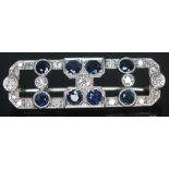 An Art Deco diamond and sapphire brooch of rectangular form and featuring 21 round cut diamonds