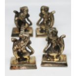 A pair of silver plated knife rests in the form of lions with shields, length 10cm.