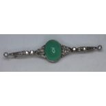 An Art Deco diamond and green cabochon brooch, cracfted in white metal, unmarked, length 78mm, gross