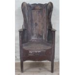 A West Lancashire three leg pine lambing chair, late 18th century with shaped, wing and panelled