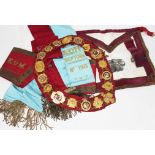 A Masonic type gilt metal sash and other regalia.