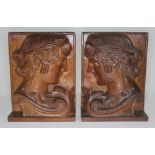 A pair of carved oak bookends, each depicting a Grecian lady in side profile, height 20cm.