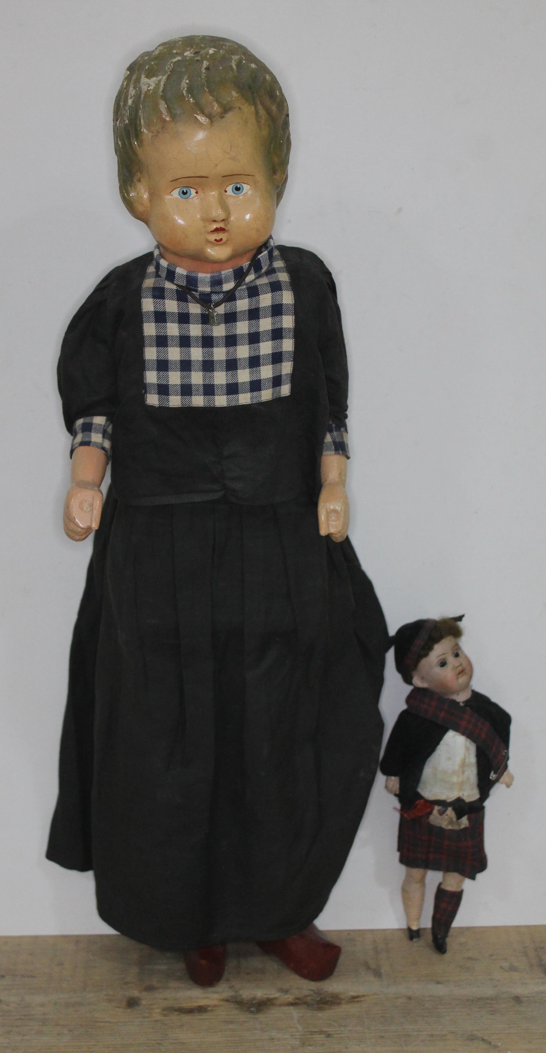 An automated doll with composition head and carved wooden limbs.