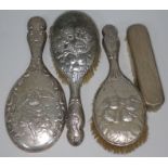 A three piece hallmarked silver dressing table set and another brush.